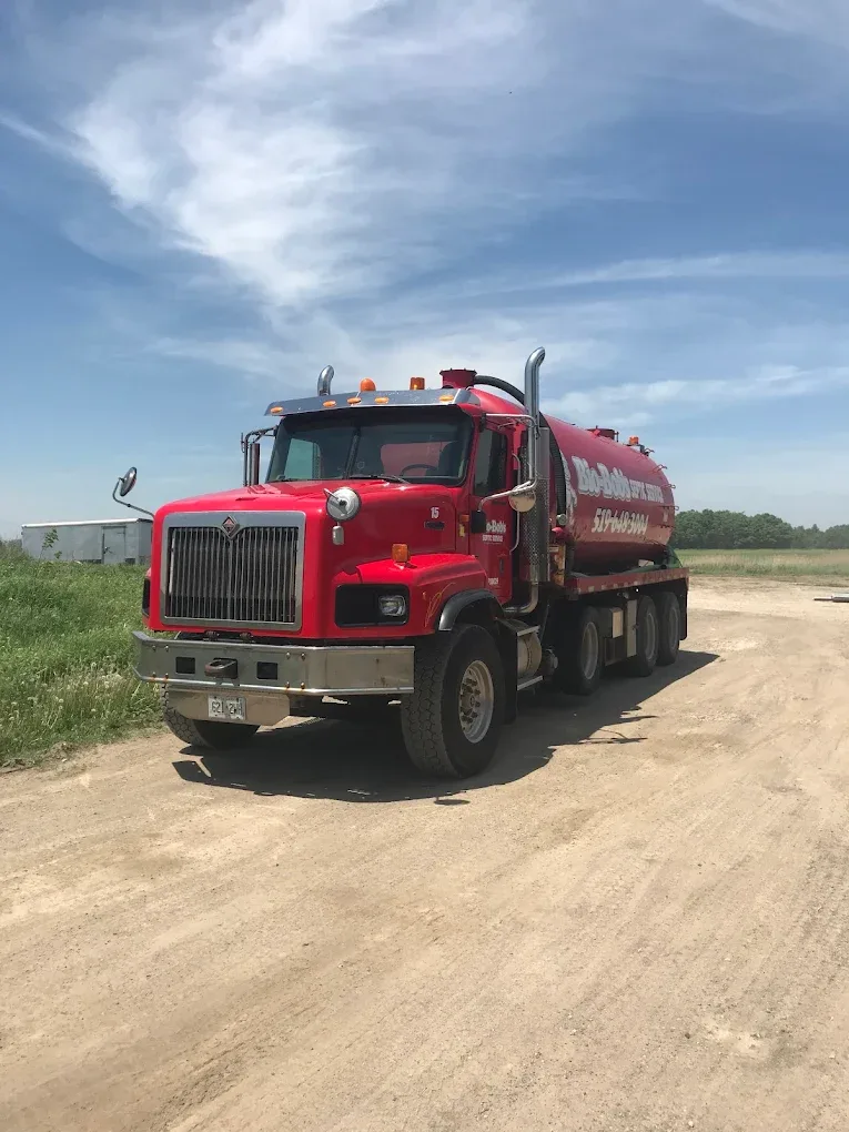 Bio-Bob's red International vacuum tanker under a blue sky